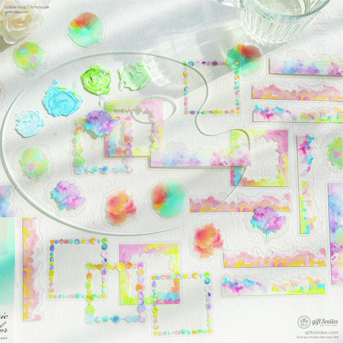 Colorful watercolor sticker set featuring floral and abstract designs on a light art studio background