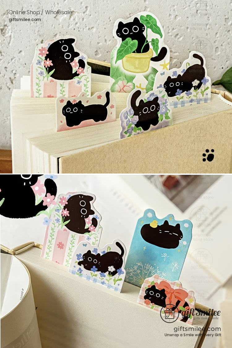 Cute black cat sticky bookmarks peeking from books with floral and plant designs  