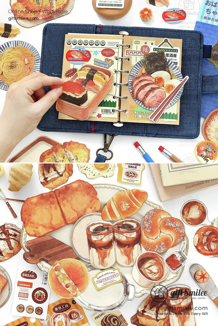 Food-themed scrapbook stickers with bread, pastries, and breakfast drinks arranged around an open planner.