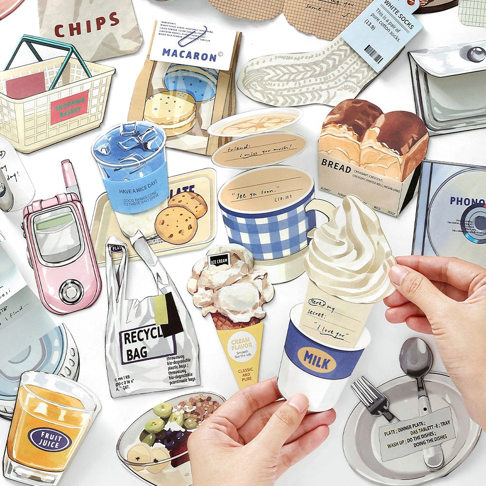 Assorted paper cutouts of colorful food items drinks and household objects including ice cream cookies and a milk cup