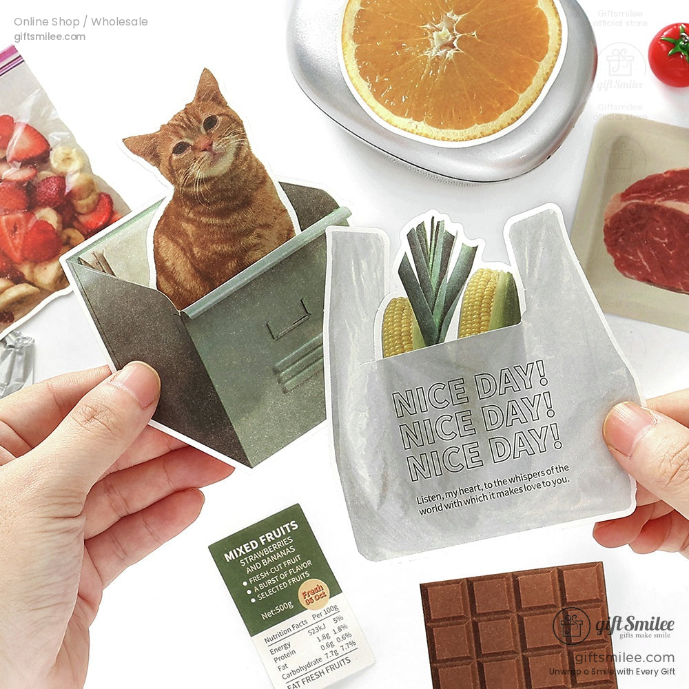 Quirky stickers of a ginger cat in a green trash bin and vegetables in a gray bag with playful Nice Day text