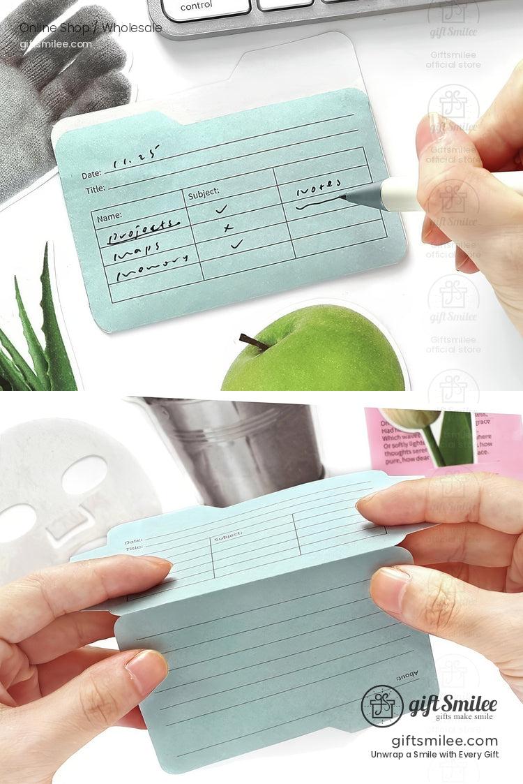 Light blue notepad shaped like a file folder featuring a writable grid layout for notes with a pen and desk accessories