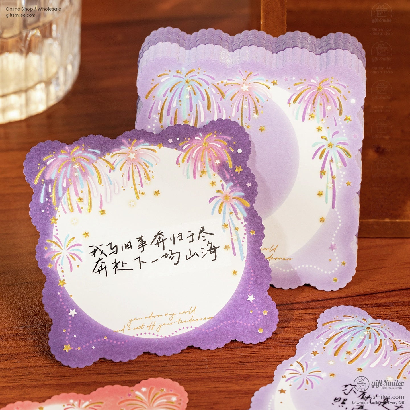 Purple scallopededge stationery with pastel fireworks gold stars and delicate gradient moon design on a wooden surface