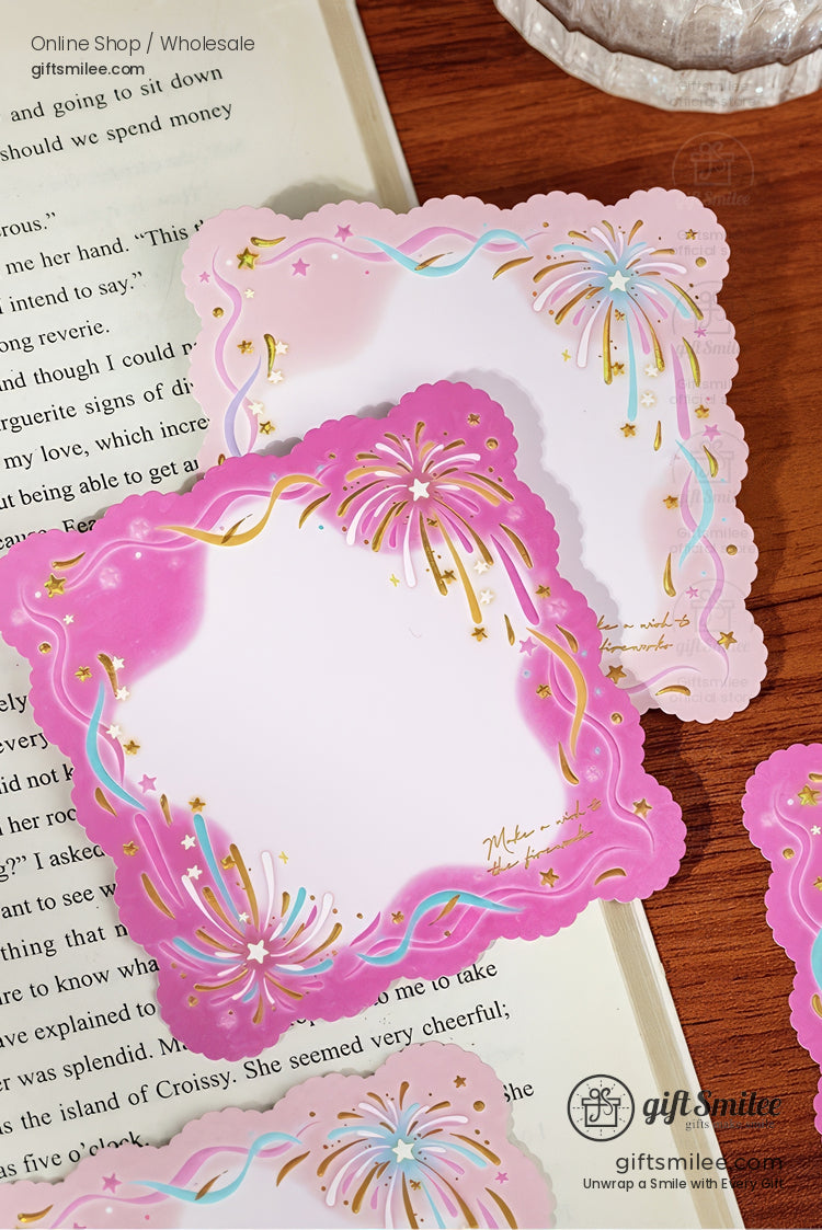 Pink scallopededge notepads with gold foil fireworks pastel accents and whimsical design on a wooden table