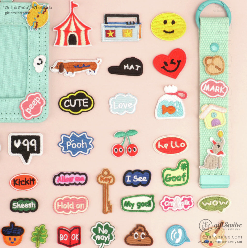 Colorful embroidered patches and keychain featuring playful shapes icons text and designs on a pastel background