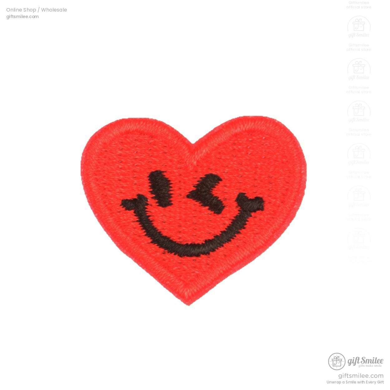 Red embroidered heart patch with a black smiling face design and textured stitching