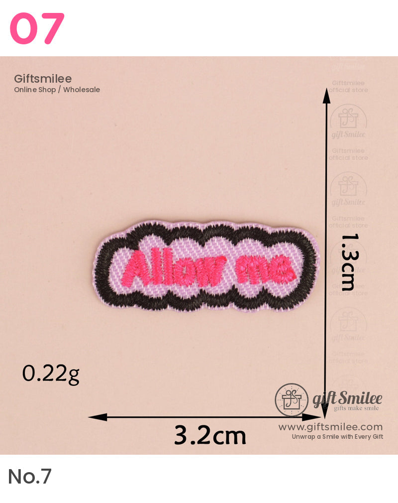 Pink and black embroidered patch with Allow me text 32cm by 13cm lightweight at 022g on beige background