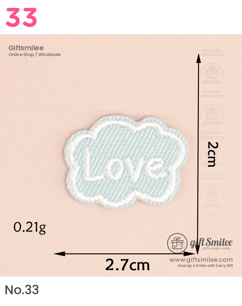 Light blue embroidered cloudshaped patch with Love text in white thread 27cm wide and 2cm tall