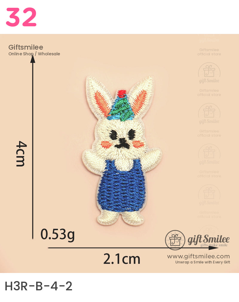Colorful embroidered rabbit patch with blue overalls green party hat and red pompom measuring 4cm by 21cm