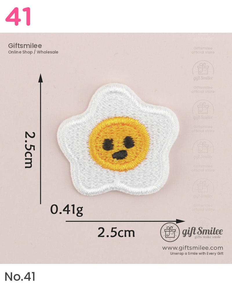 White starshaped embroidered patch with a yellow smiley face black details and compact 25 cm size