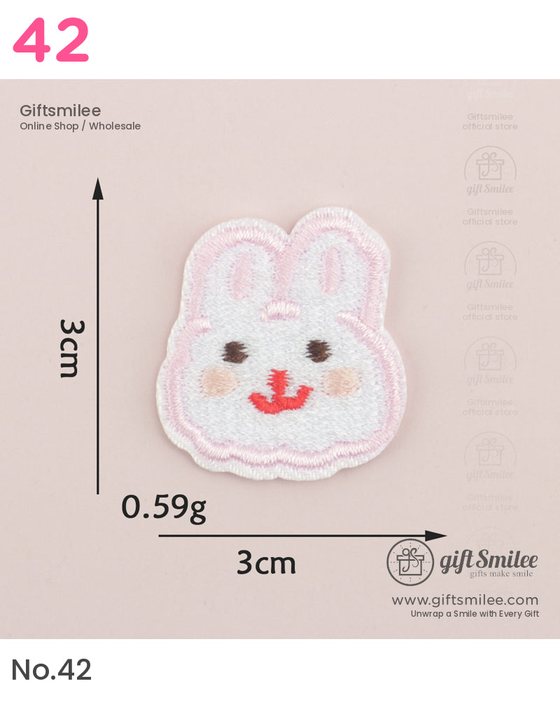 White embroidered bunny patch with pink outline rosy cheeks red smile and black eyes measuring 3cm by 3cm