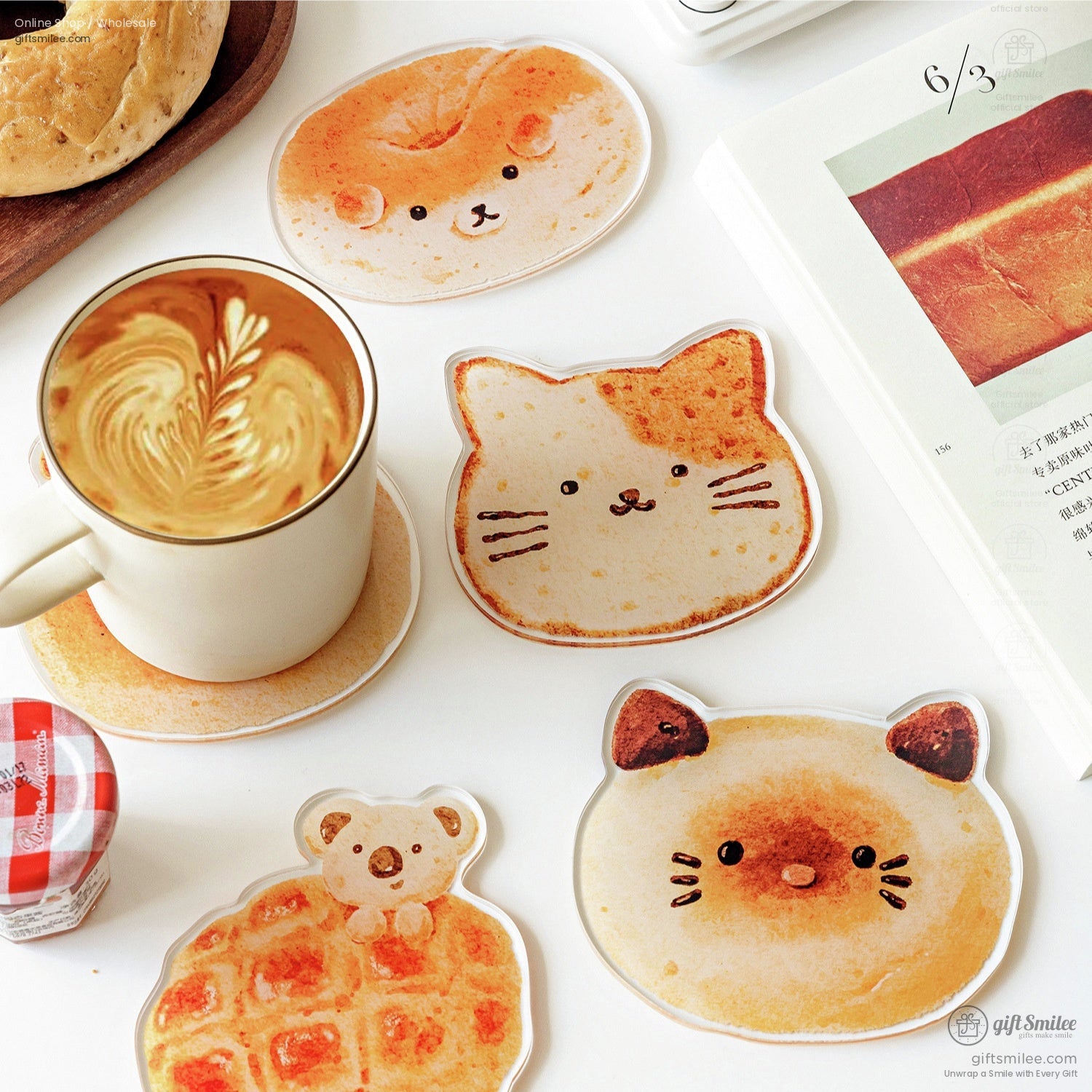 Cat-shaped bread coaster next to a latte and book