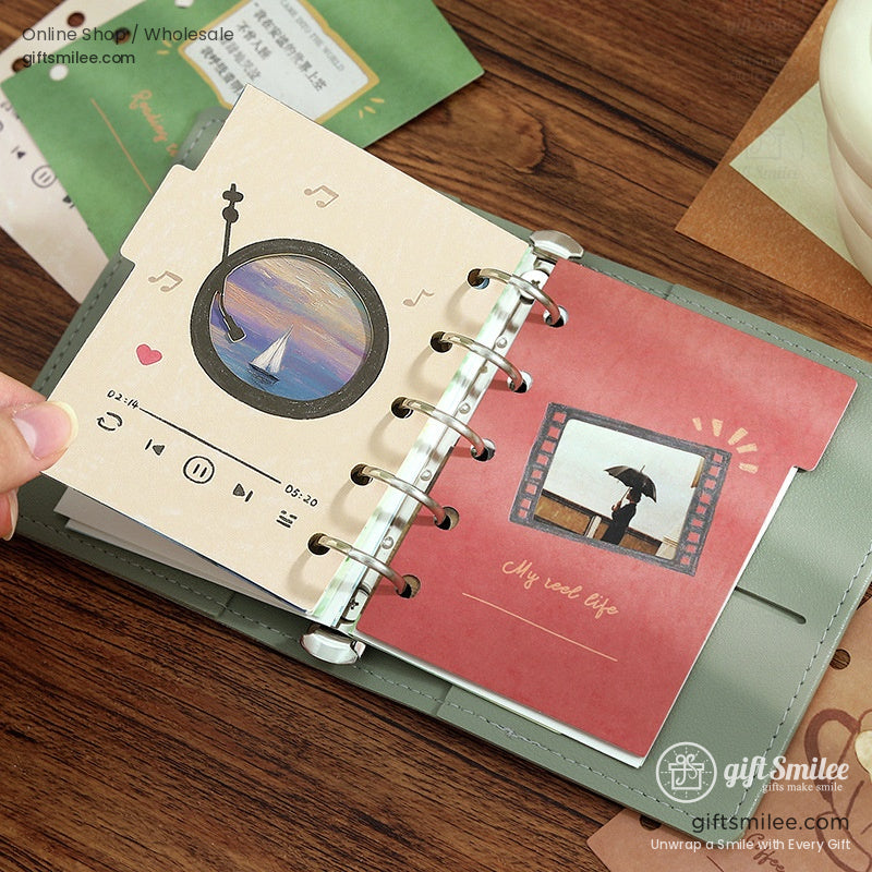 Blue and purple planner dividers with swan and bird motifs inside a ring-bound notebook