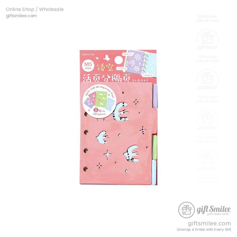 Close-up of a pink laser-cut divider insert with bird and star patterns