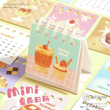 Mini desktop calendar featuring cute dessert illustrations with spiral binding for desk use