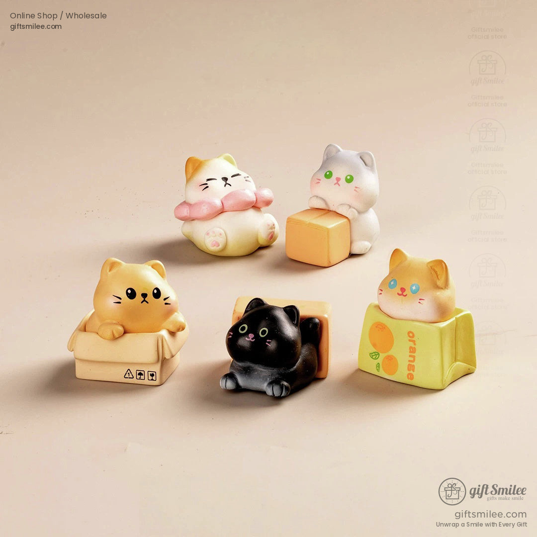 Set of cute cat figurines in pastel tones featuring playful poses with boxes blocks and soft detailing