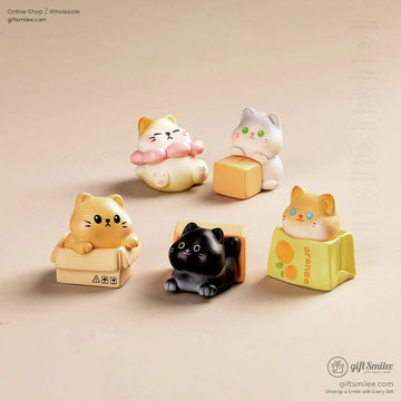Set of cute cat figurines in pastel tones featuring playful poses with boxes blocks and soft detailing
