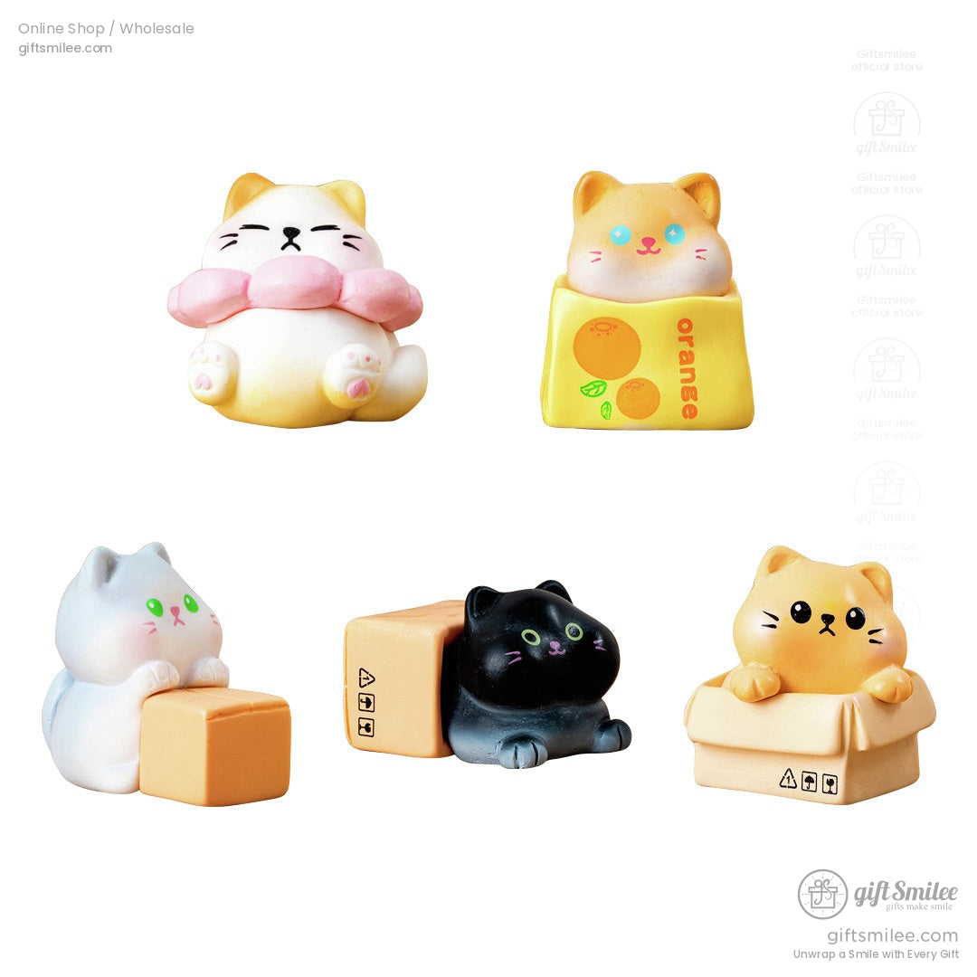 Set of five colorful cat figurines with playful designs featuring boxes fruit themes and expressive faces