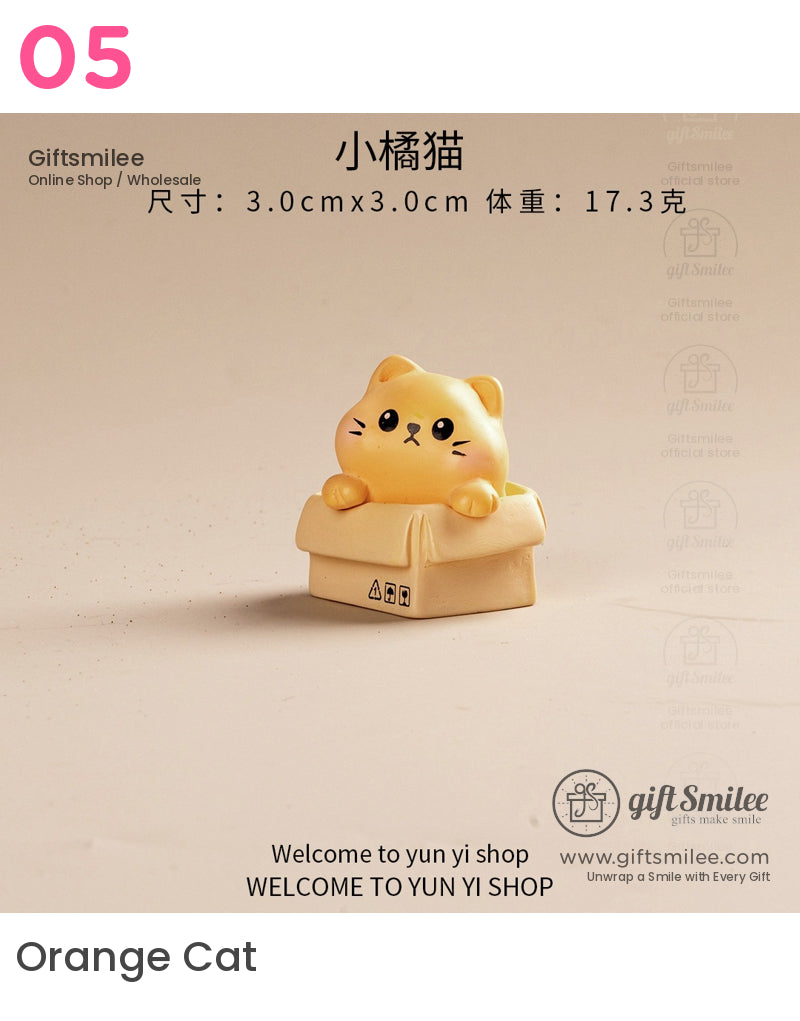 Cute orange cat figurine peeking out of a beige cardboard box crafted from smooth resin with a playful expression