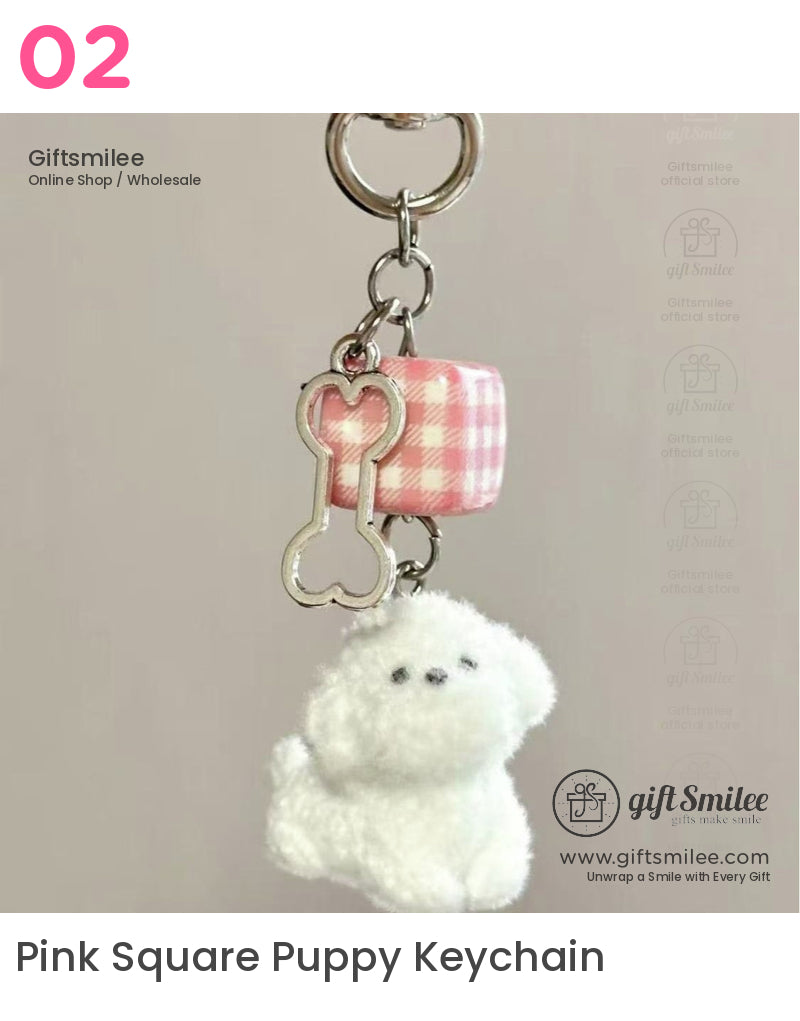 Fluffy white dog keychain with pink gingham cube charm and silver boneshaped pendant on metallic ring clasp
