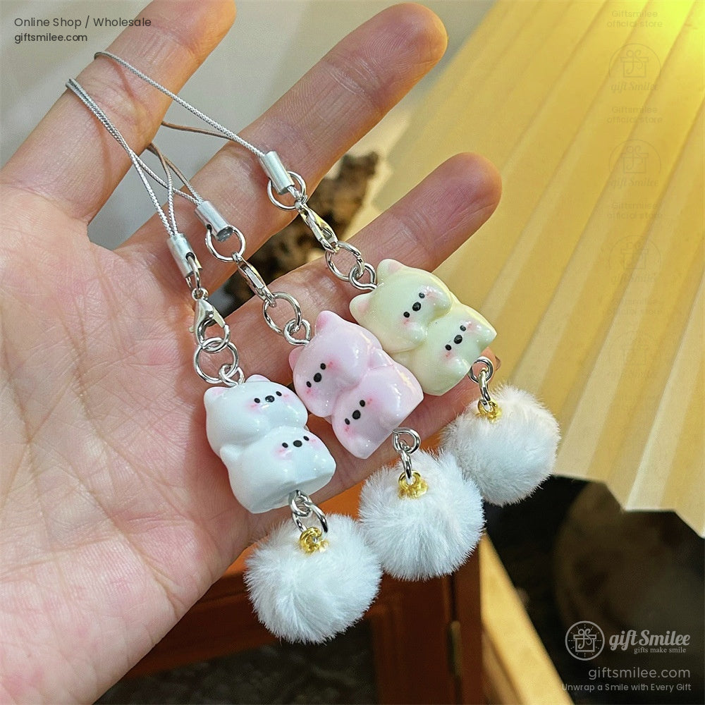 Pastel ceramic cat charms in white pink and yellow hung on silver straps accented with soft white fauxfur pompoms