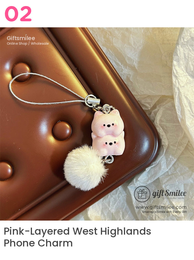 Pink ceramic pig charm with glossy finish fluffy white pompom and silver chain on a brown textured background