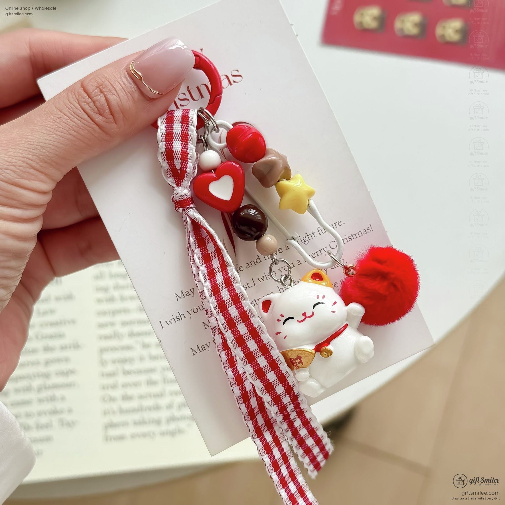 Red and white gingham ribbon keychain with lucky cat charm heart beads star accent and a fluffy pompom