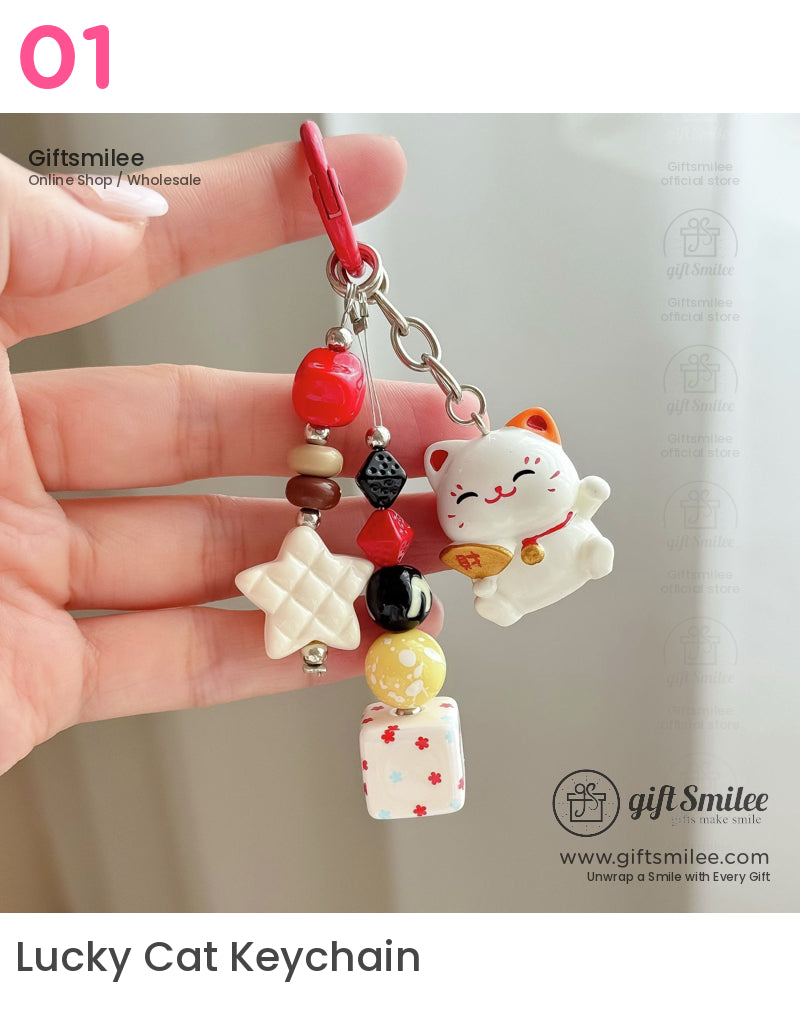 Multicolor beaded keychain with ceramic lucky cat charm red clip textured star and floral cube accents