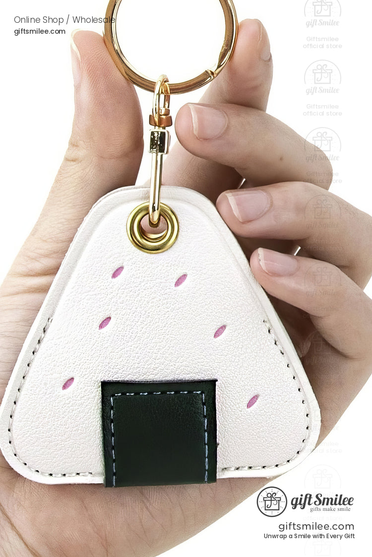 White faux leather onigiri keychain with pink accents green stitched pocket and gold keyring clasp