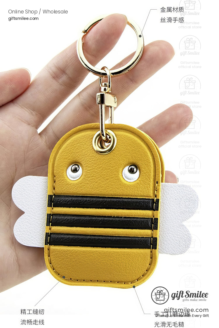 Yellow faux leather bee keychain with black stripes white wings metal ring and stitched details