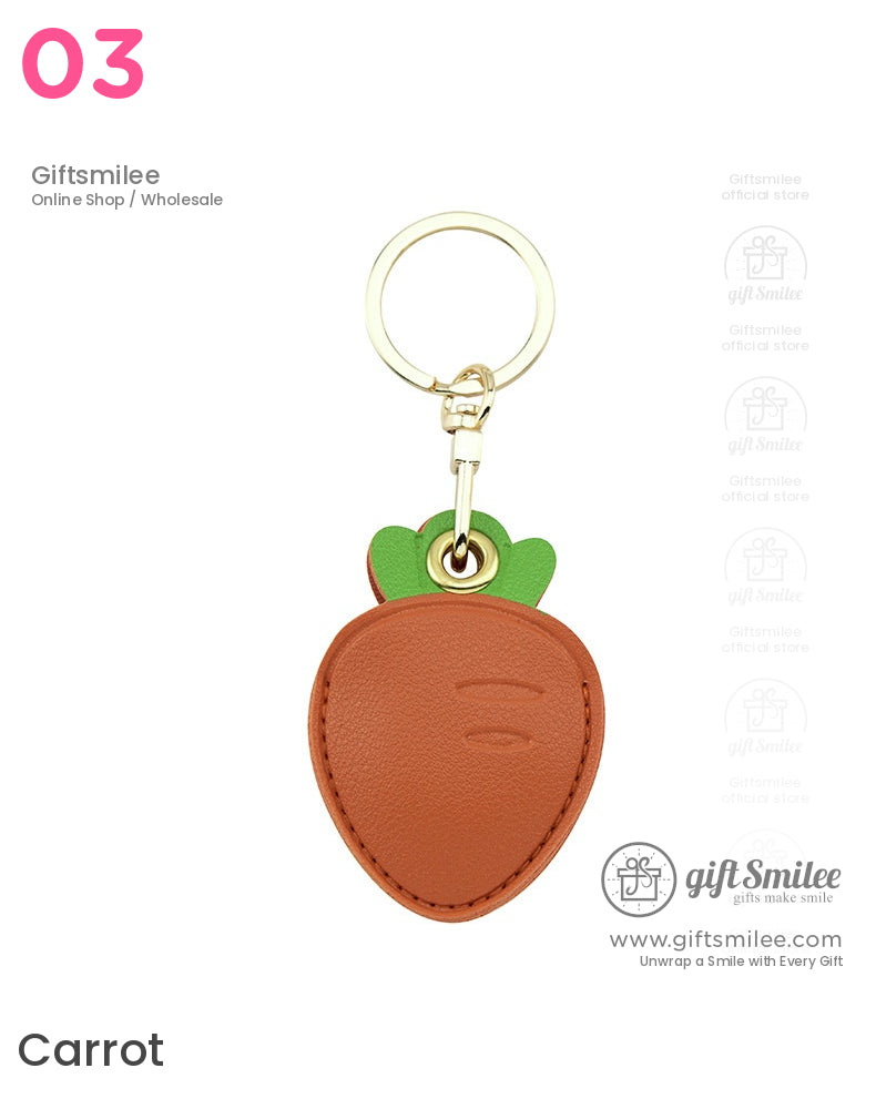 Brown leather carrotshaped keychain with green top accents and goldtone metal keyring