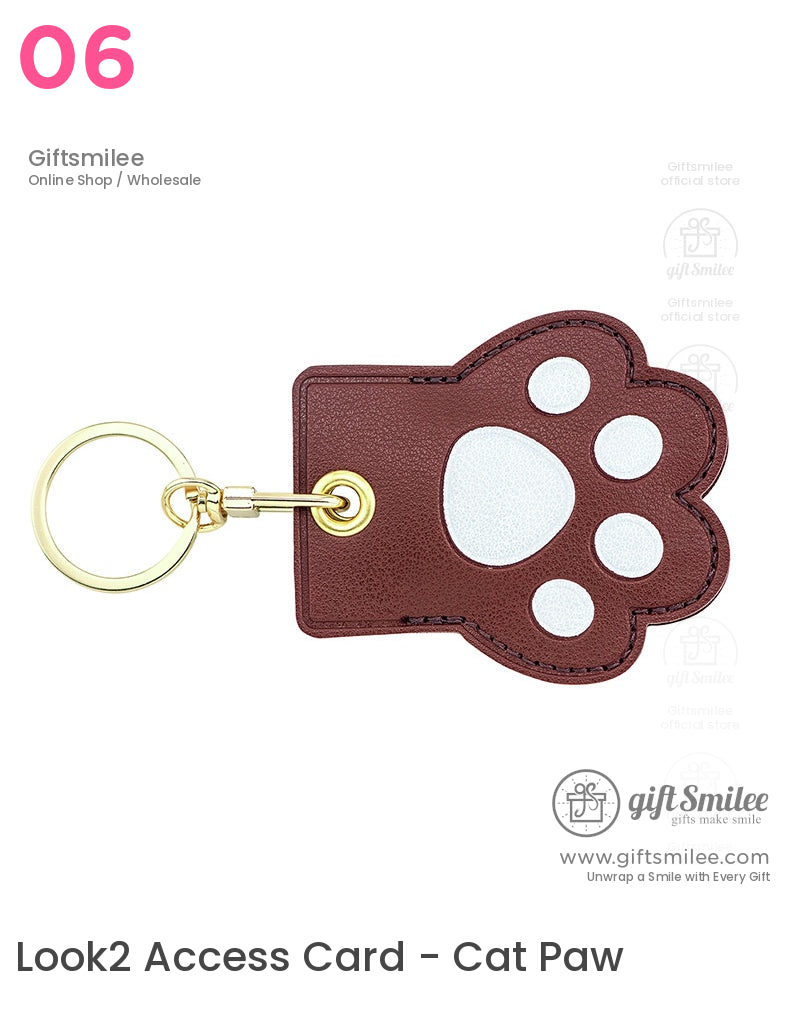 Brown faux leather pawshaped keychain with white paw print details and a golden keyring attachment