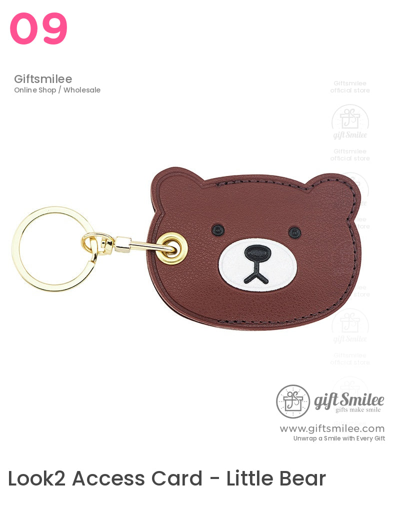 Brown bearshaped faux leather keychain with stitched details white snout black nose and a gold metal ring