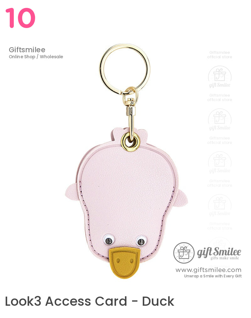 Pastel pink leather duckshaped keychain with stitched edges googly eyes yellow beak and goldtoned metal ring