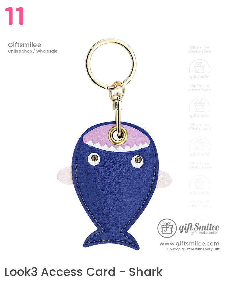 Blue fishshaped leather keychain with pink accents stitched edges and a gold metal ring attachment