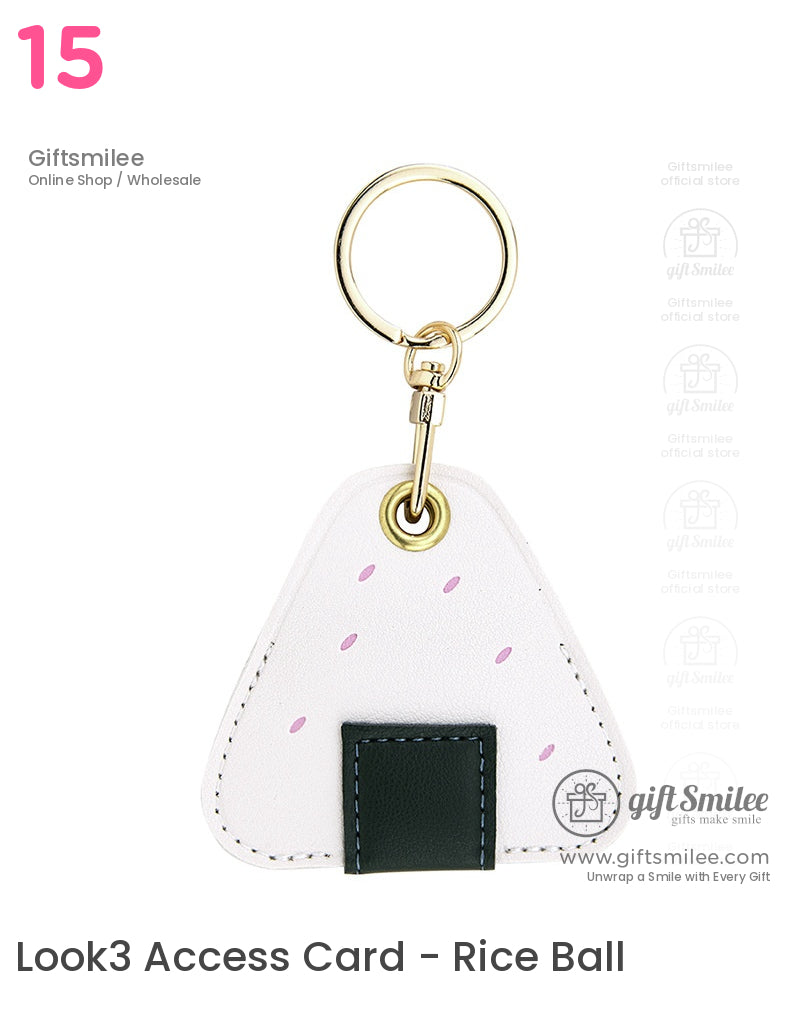 White triangular faux leather keychain with pink accents dark green stitched pocket and a gold metal keyring
