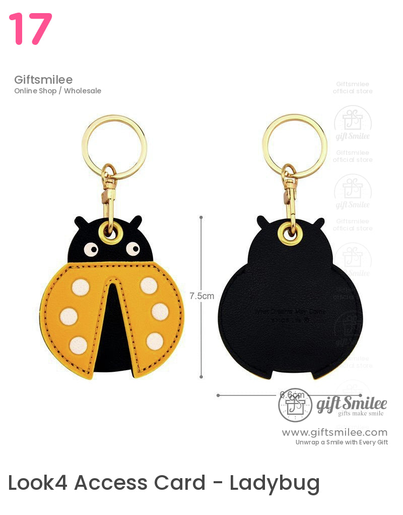 Yellow and black ladybugshaped faux leather keychain with white polka dots and goldtone metal keyring