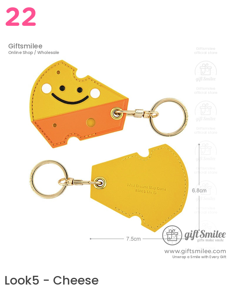 Smiling cheeseshaped yellow and orange leather keychain with goldtone ring and embossed text detailing