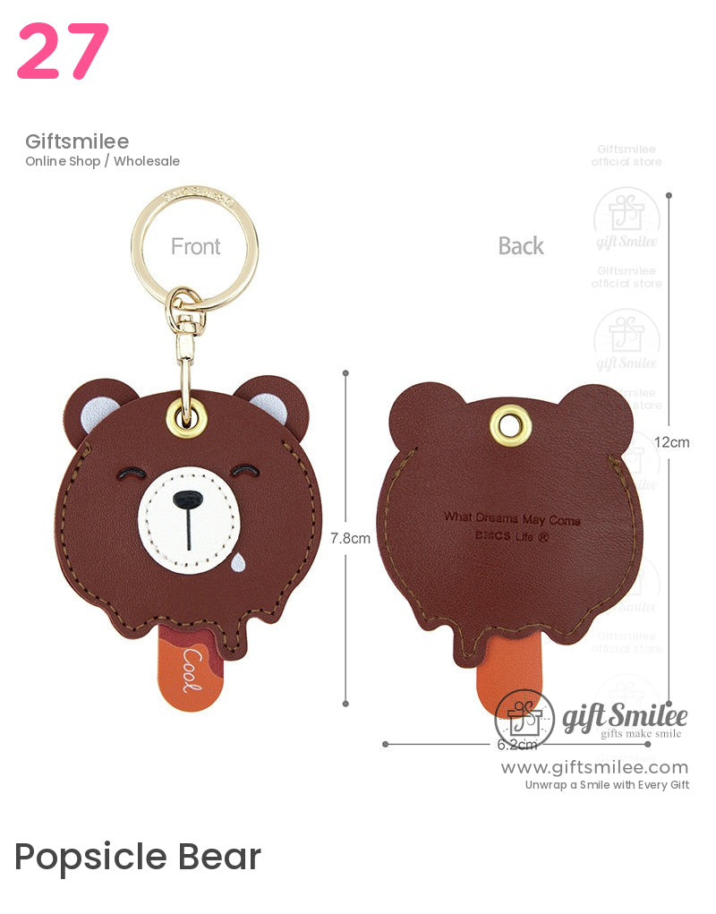 Brown leather bearshaped keychain with gold ring embroidered face orange tag and measurements indicated