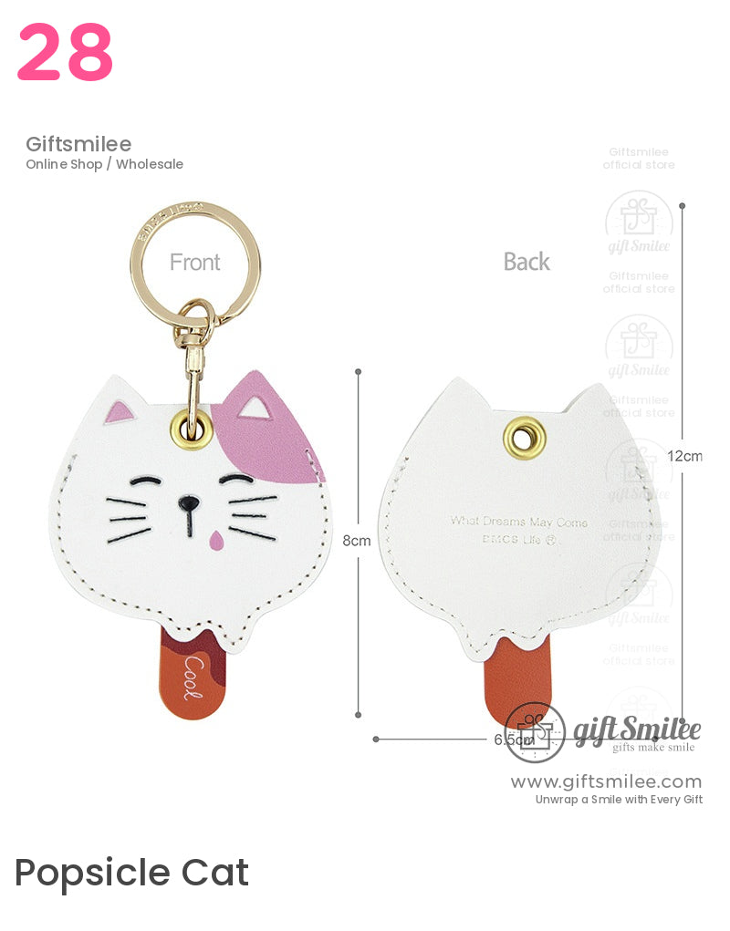 White faux leather catshaped keychain with gold ring pink ear detail engraved back text and orange tab accent