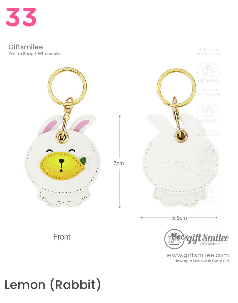 White faux leather rabbit keychain with pink ears yellow lemon detail goldtone metal ring and stitched edges
