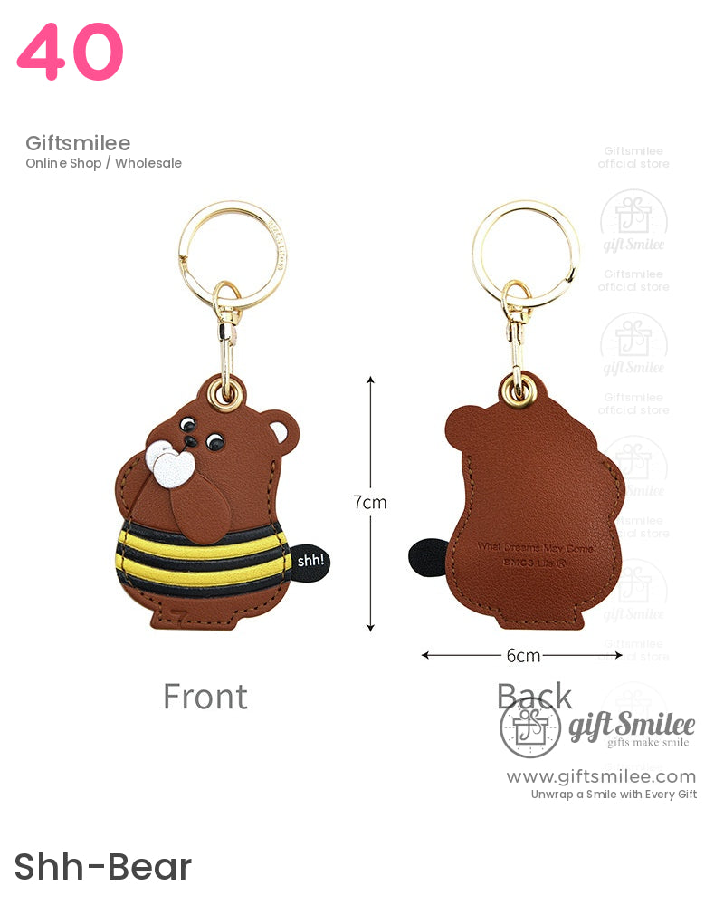 Brown bearshaped faux leather keychain with gold metal ring black and yellow striped shirt and shh detail