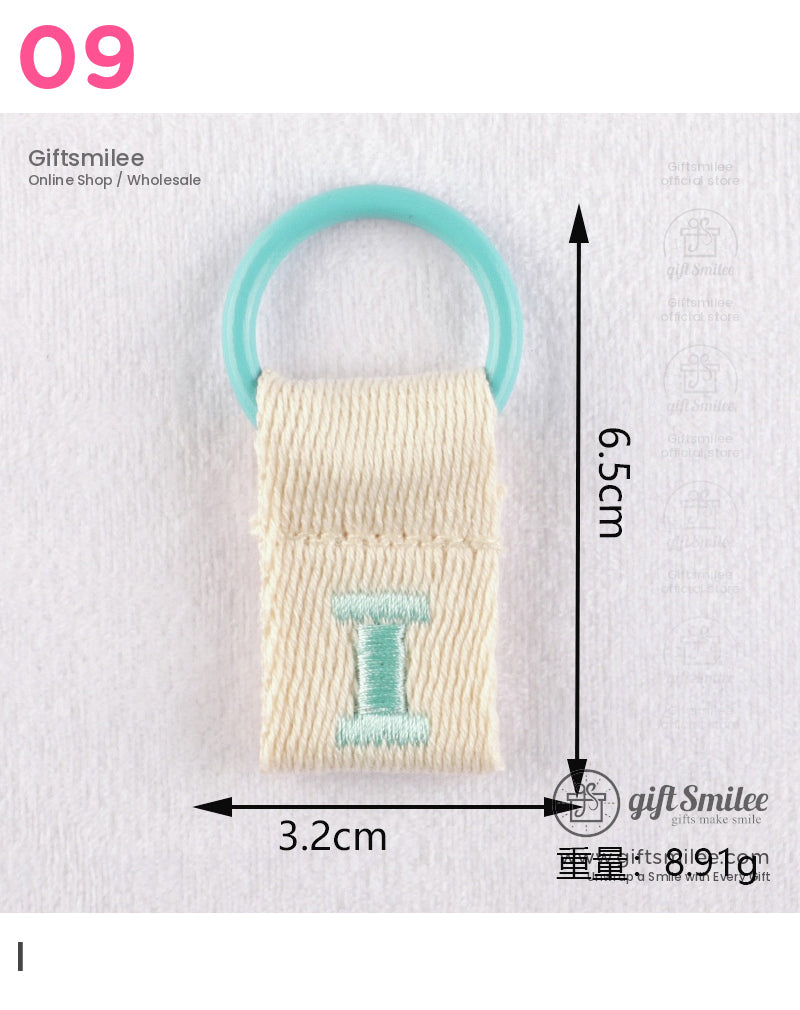 Beige woven fabric loop with teal embroidered I attached to a turquoise plastic ring measuring 65cm by 32cm