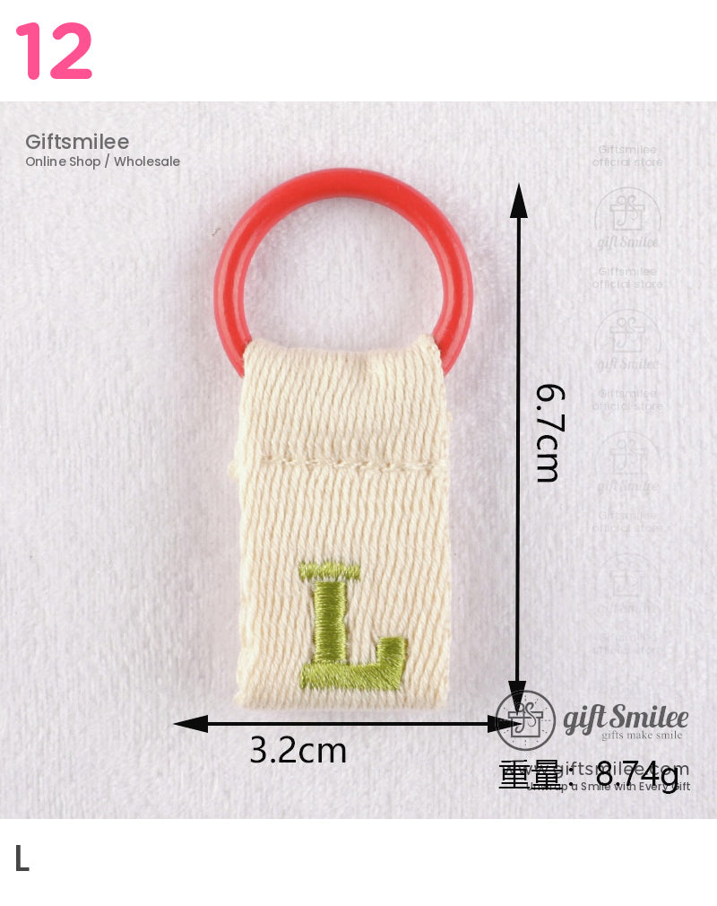 Beige woven cotton keychain with red circular ring and green embroidered L measuring 67cm by 32cm