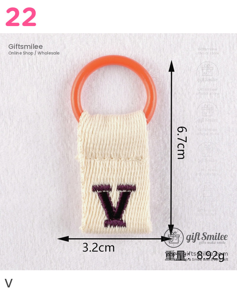 Beige cotton keyring with orange plastic loop purple embroidered V compact 67cm x 32cm dimensions lightweight