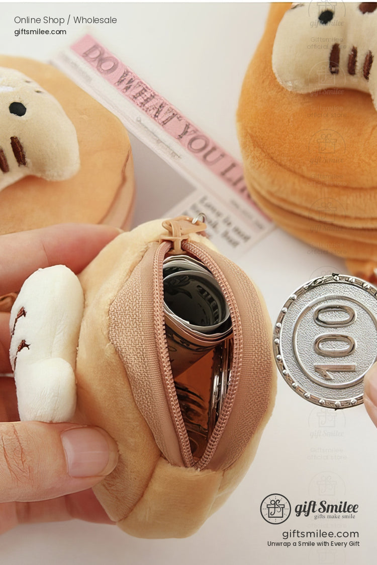 Tan plush coin pouch shaped like bread with a zippered opening soft white paw accents and playful embroidered details