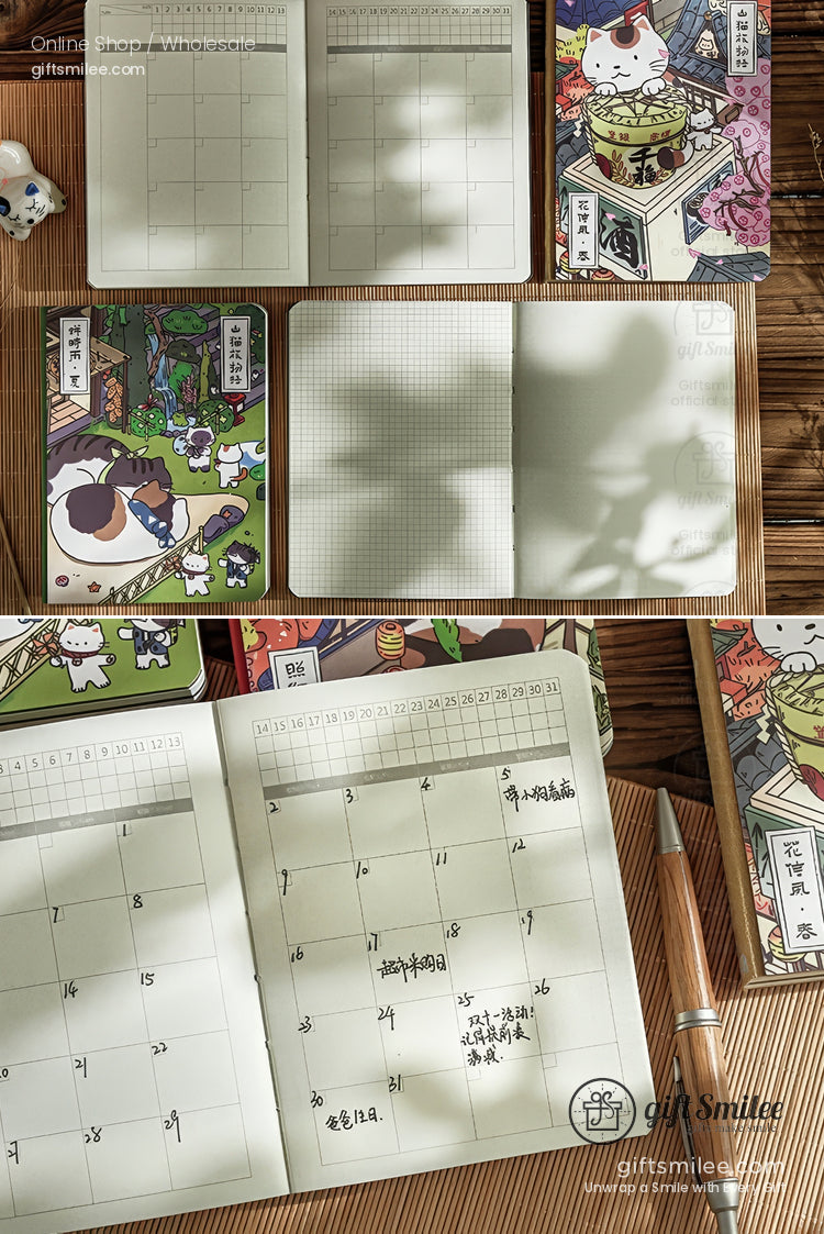 Monthly planner with grid pages cute catthemed covers colorful illustrations and a wooden pen on a bamboo surface