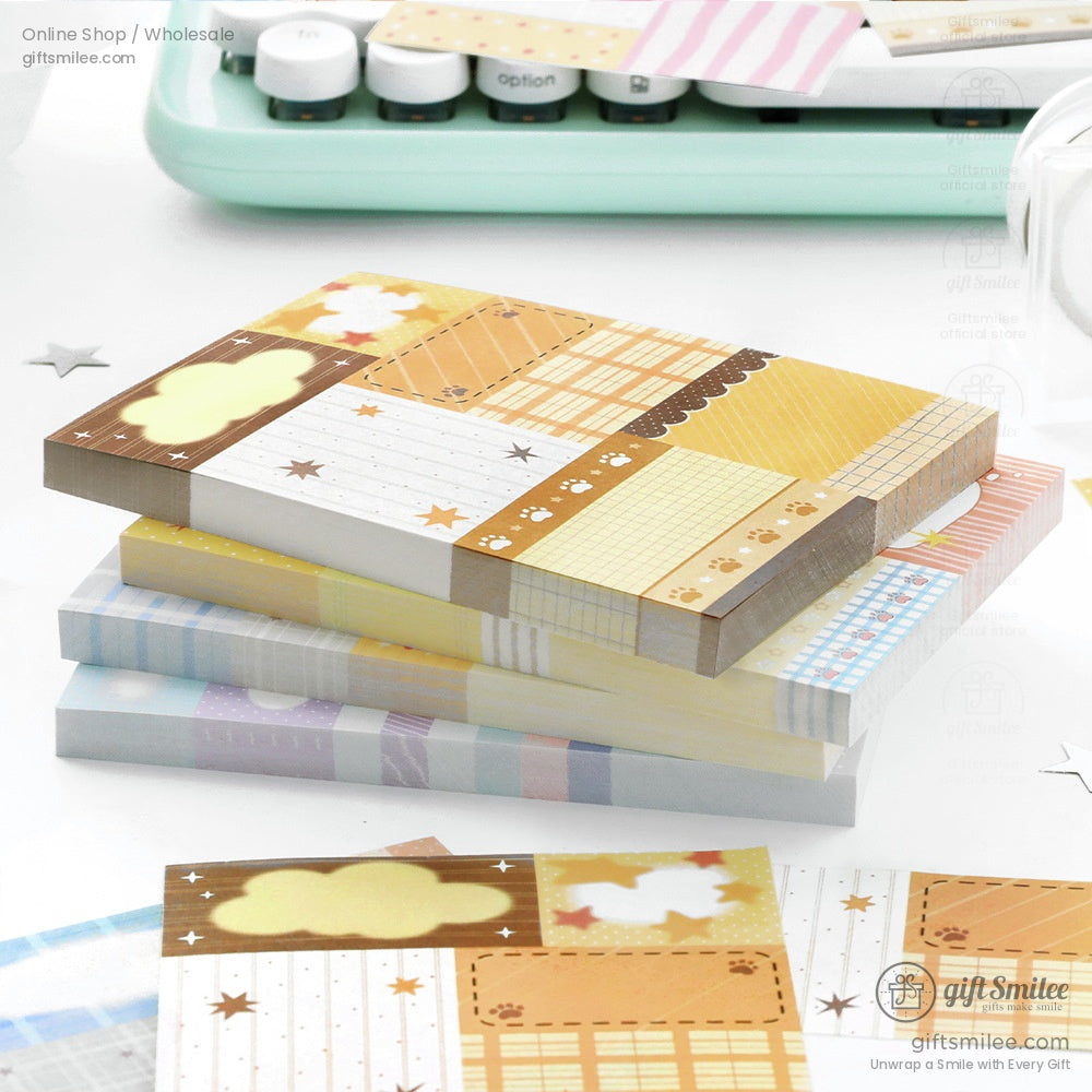 Stack of colorful patterned sticky note pads with star grid paw print and cloud designs in pastel and warm tones