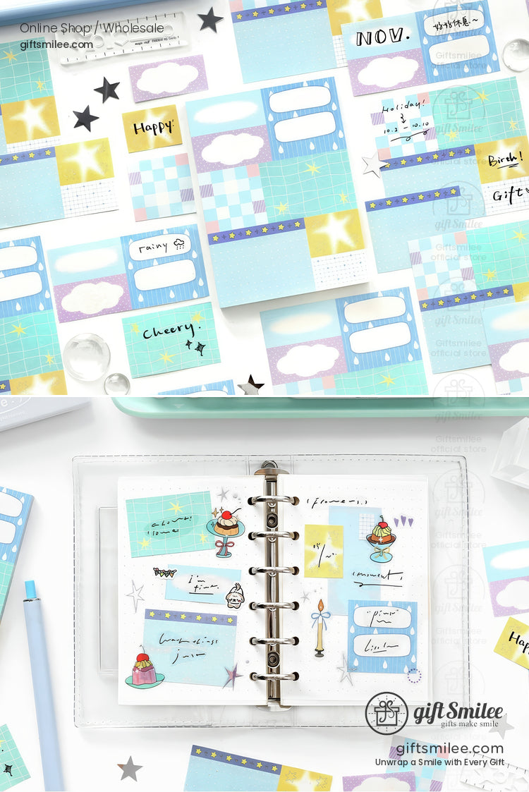 Pastel blue and yellow planner stickers with clouds stars grids and labels next to an open ringbound organizer