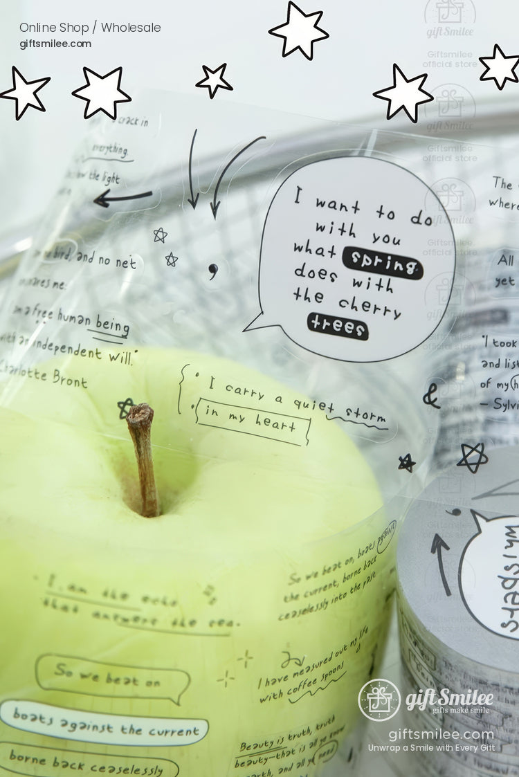 Transparent gift bag with handwritten doodles and quotes wrapped around a green apple, giftSmile branding visible.